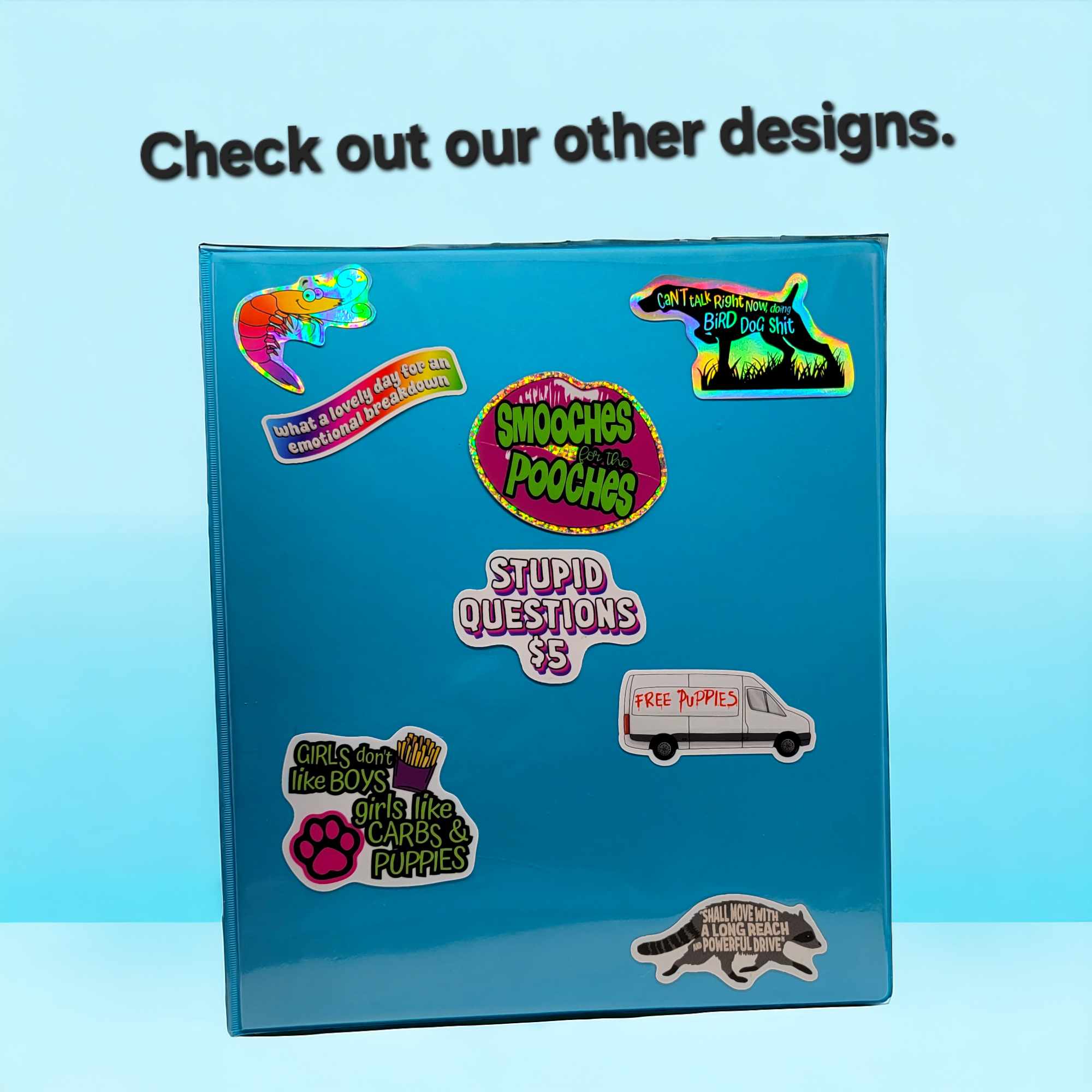 A bright blue binder covered with stickers to show a possible use for Trash Panda&#39;s Closet stickers, with the text &quot;check out our other designs&quot; at the top.