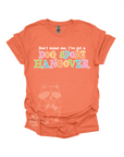 Orange t-shirt with colorful text that reads, "Don't mind me, I've got a DOG SPORT hangover".