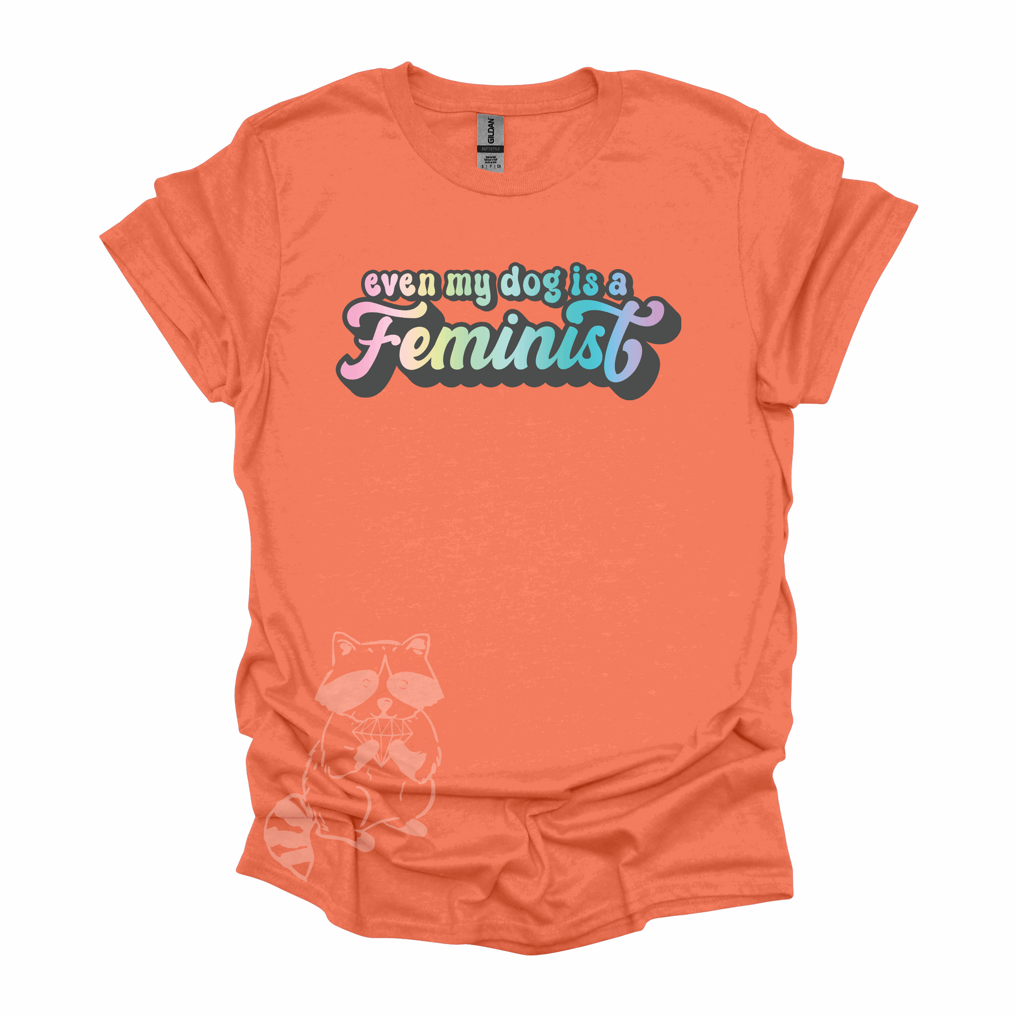 "Even My Dog Is A Feminist" printed in a pastel rainbow gradient in a vintage font on an orange t-shirt.