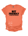 An orange t-shirt with the text "NOT FRIENDLY the dog is also sketchy af" printed in black.