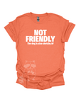 An orange t-shirt with the text "NOT FRIENDLY the dog is also sketchy af" printed in white.