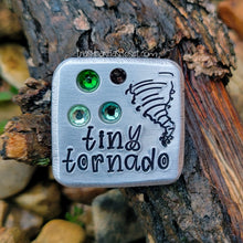 Load image into Gallery viewer, Silver square handmade pet identification tag with the words &quot;tiny tornado&quot;, a tornado design, and three different shades of green crystals.
